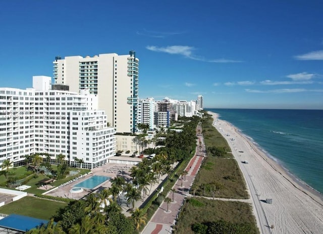 aerial view featuring a view of the beach, a water view, and a view of city