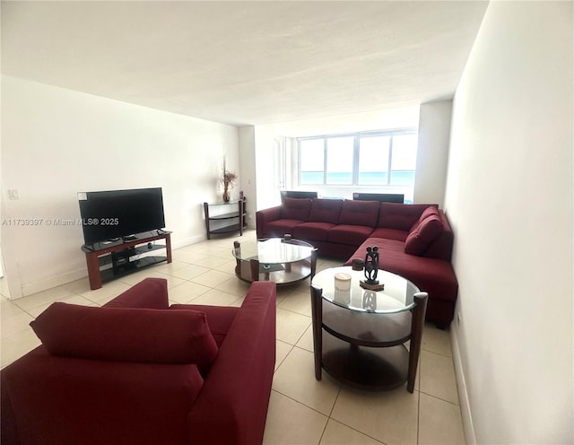 living room with light tile patterned floors and baseboards