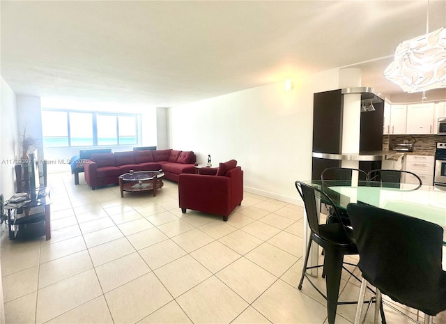 living area with light tile patterned floors and baseboards