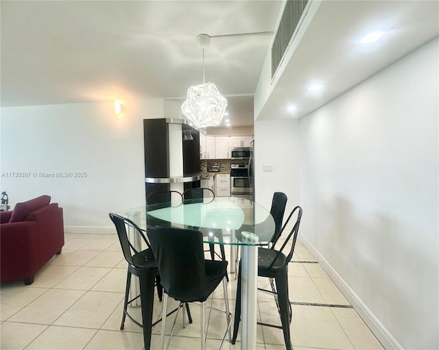 5005 Collins Ave Unit 1212, Miami Beach, FL 33140 - dining space featuring light tile patterned floors, baseboards, and a chandelier