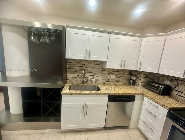 5005 Collins Ave Unit 1212, Miami Beach, FL 33140 - kitchen with stainless steel appliances, a sink, light tile patterned flooring, and white cabinets
