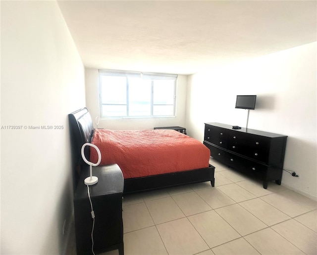 bedroom featuring light tile patterned flooring