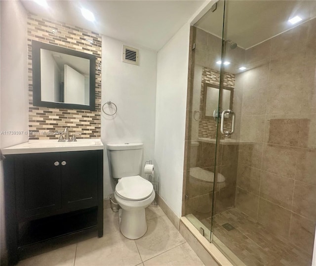 5005 Collins Ave Unit 1212, Miami Beach, FL 33140 - bathroom with a shower stall, tasteful backsplash, vanity, toilet, and tile patterned flooring
