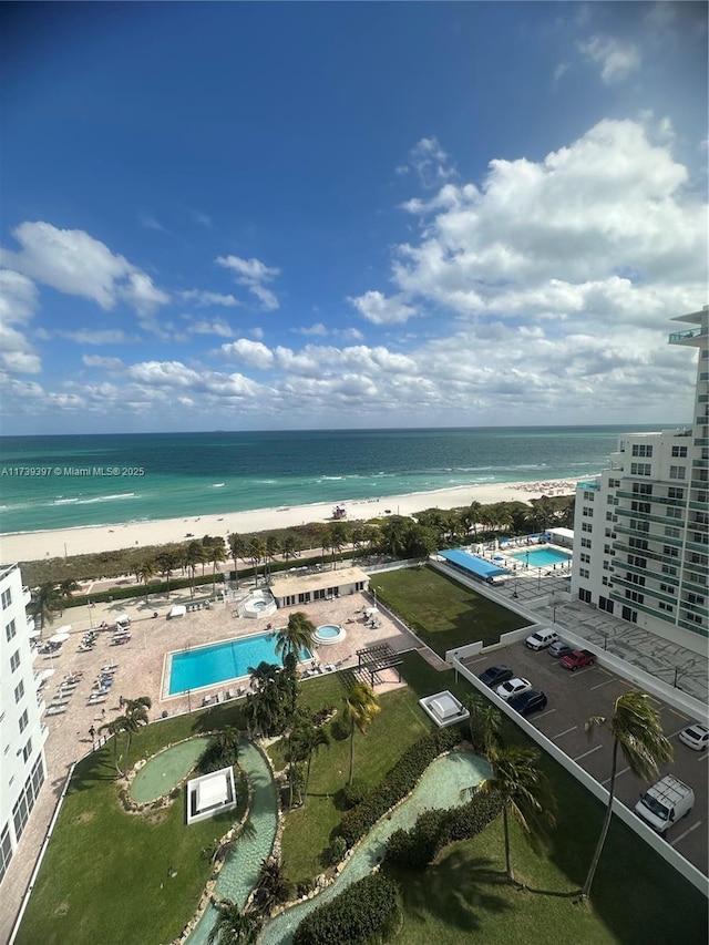 drone / aerial view with a water view and a beach view