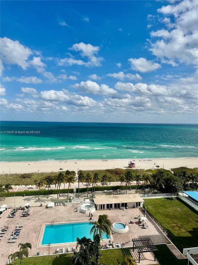 bird's eye view featuring a water view and a beach view