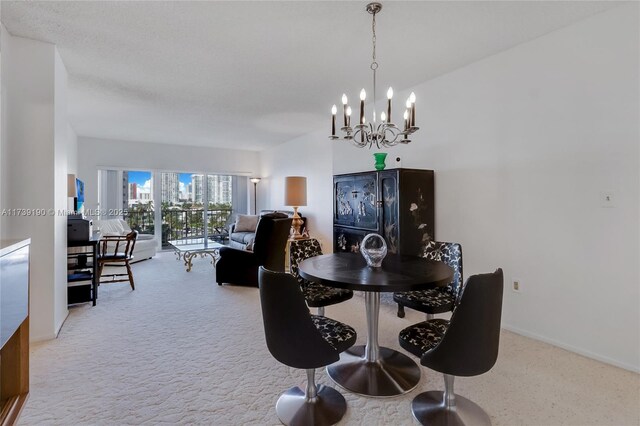 dining space featuring light colored carpet and a notable chandelier