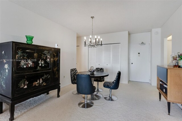 carpeted dining room with a notable chandelier