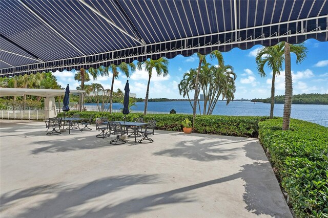 view of home's community with a water view and a patio area