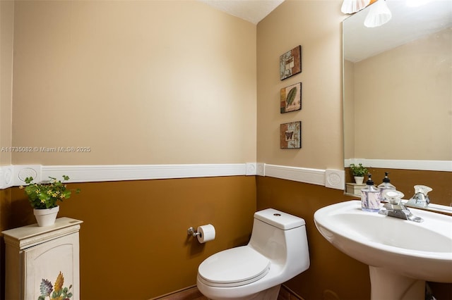 bathroom featuring sink and toilet