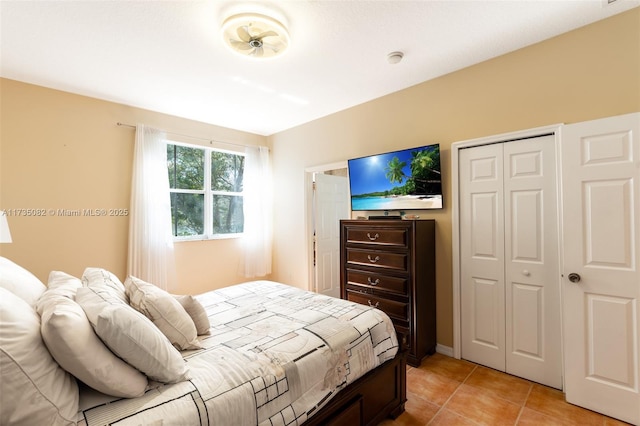 bedroom with light tile patterned floors and a closet