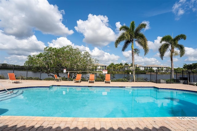 view of swimming pool with a water view