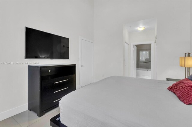 tiled bedroom featuring connected bathroom