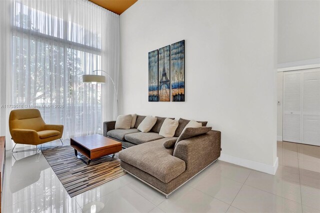 living room featuring tile patterned flooring and a towering ceiling