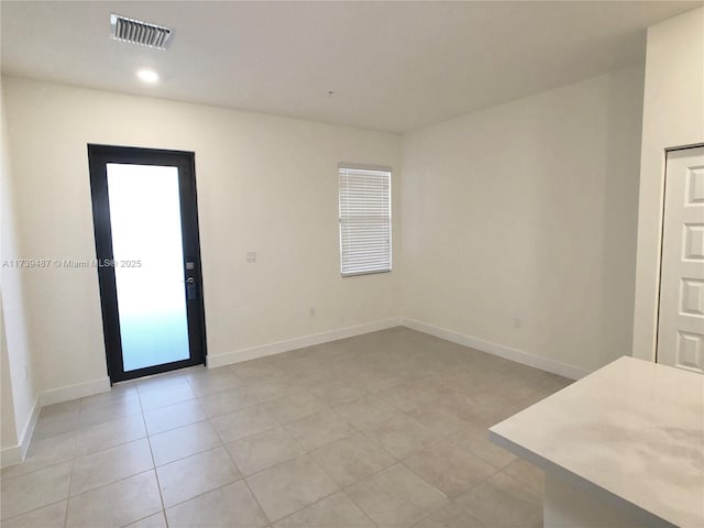 spare room with baseboards, visible vents, recessed lighting, and light tile patterned floors