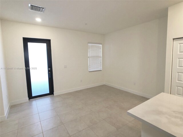 empty room with light tile patterned flooring