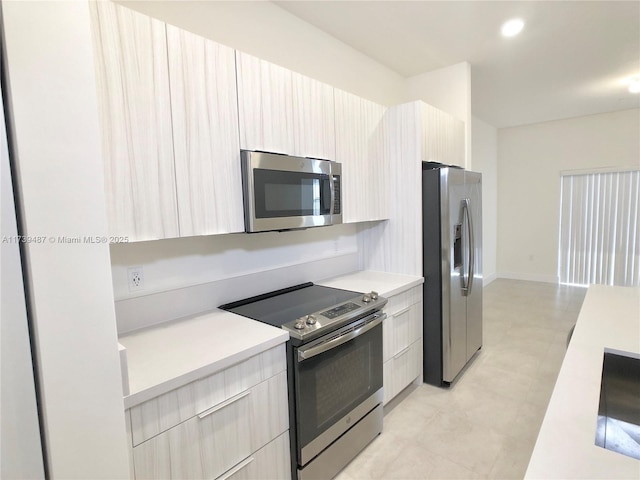 kitchen with modern cabinets, light countertops, recessed lighting, and stainless steel appliances