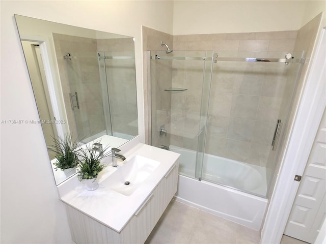 full bathroom featuring combined bath / shower with glass door, tile patterned flooring, and vanity