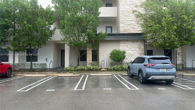 view of building exterior featuring uncovered parking