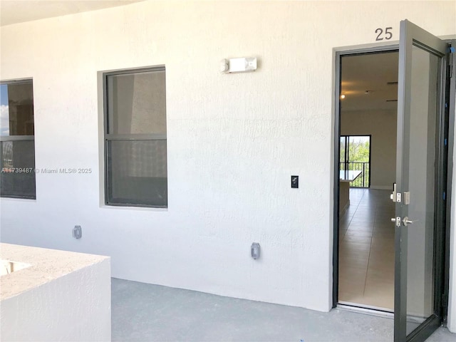 entrance to property with stucco siding