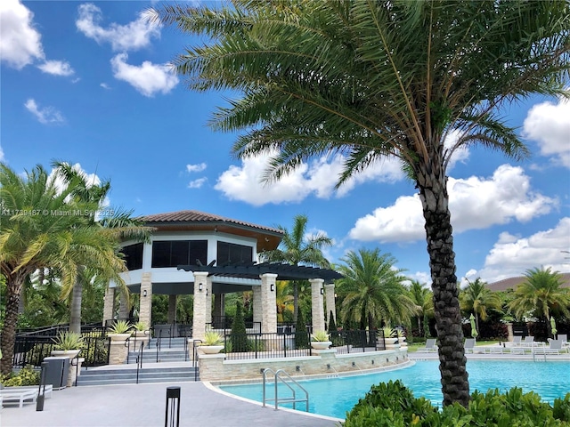 pool with a patio and fence