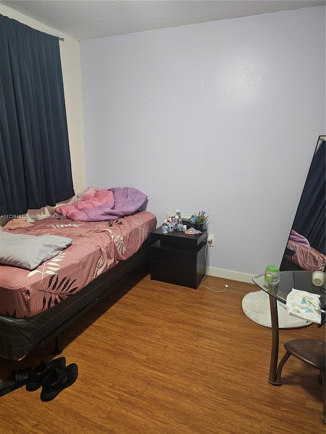 bedroom with hardwood / wood-style floors