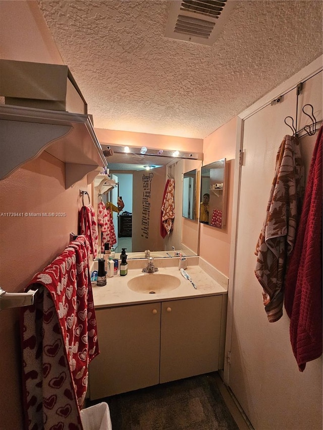 bathroom featuring vanity and a textured ceiling