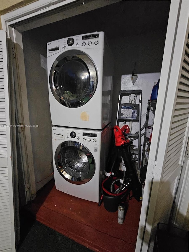 laundry room with stacked washing maching and dryer