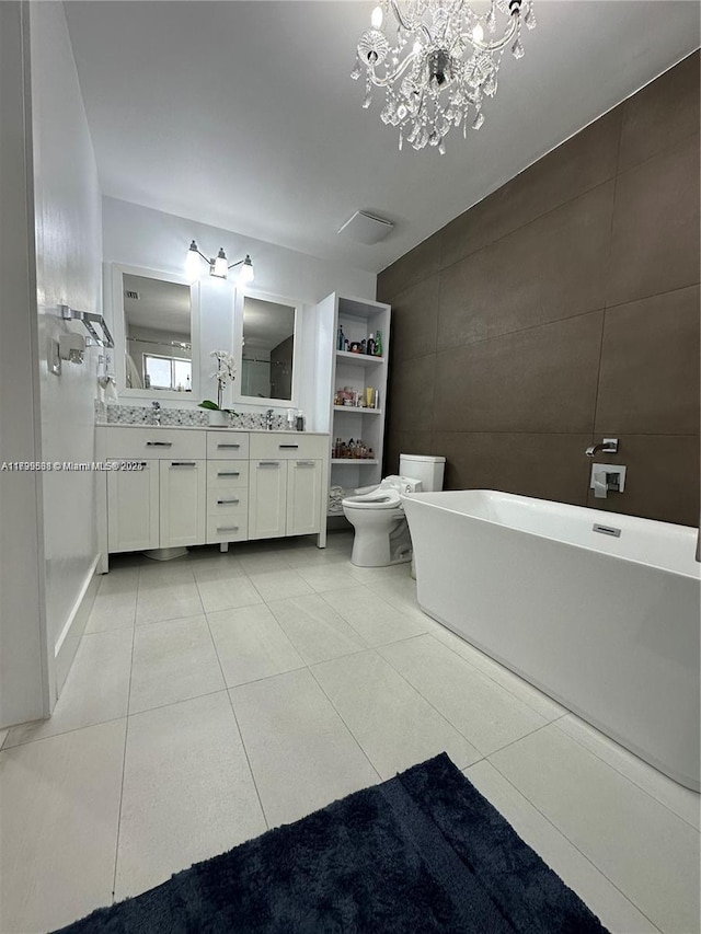 bathroom with tile walls, a bathtub, tile patterned flooring, vanity, and toilet