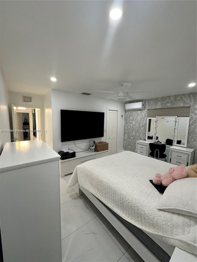 bedroom with a wall mounted AC and ceiling fan