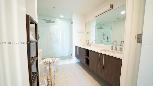 bathroom featuring tile patterned flooring, vanity, a shower with shower door, and toilet