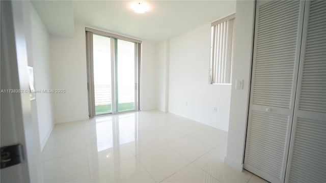 tiled spare room with expansive windows