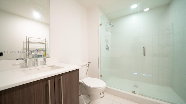 bathroom featuring vanity, tile patterned flooring, a shower with door, and toilet