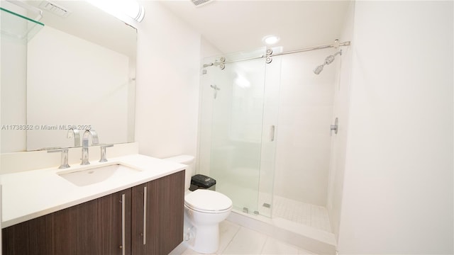 bathroom with vanity, an enclosed shower, tile patterned flooring, and toilet