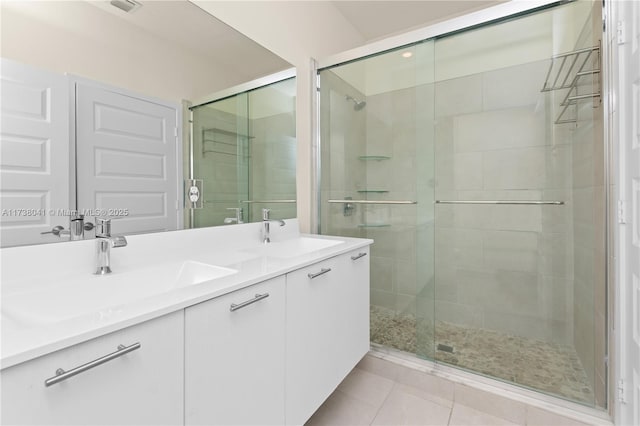 bathroom featuring vanity, tile patterned floors, and walk in shower