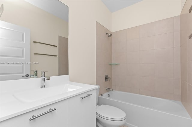 full bathroom with tiled shower / bath combo, vanity, and toilet