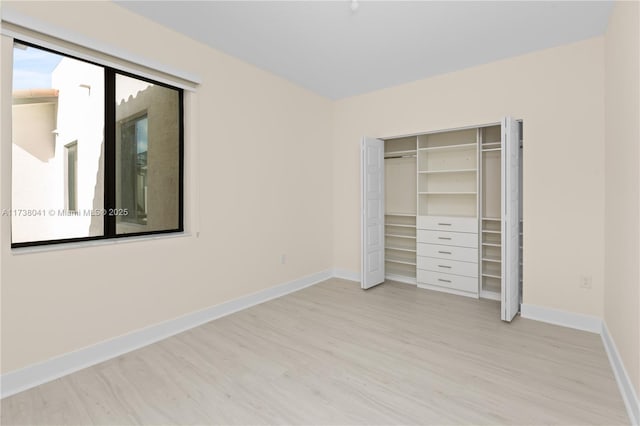 unfurnished bedroom featuring a closet and light hardwood / wood-style flooring