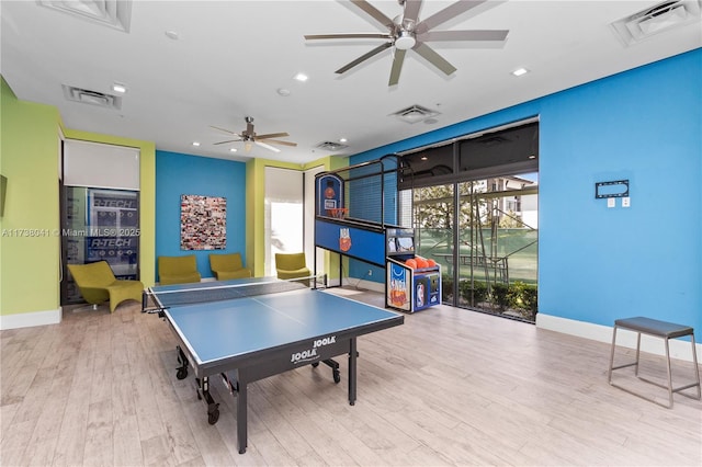 recreation room with ceiling fan and light hardwood / wood-style flooring