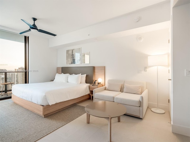 bedroom featuring expansive windows, access to exterior, and ceiling fan