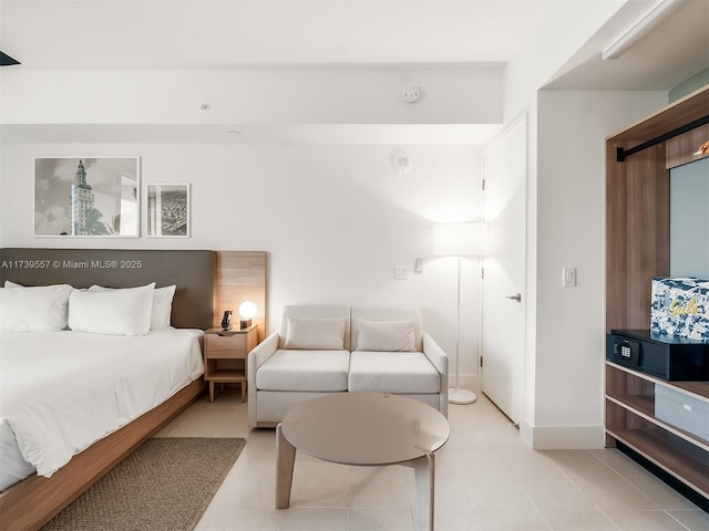 bedroom with light tile patterned floors