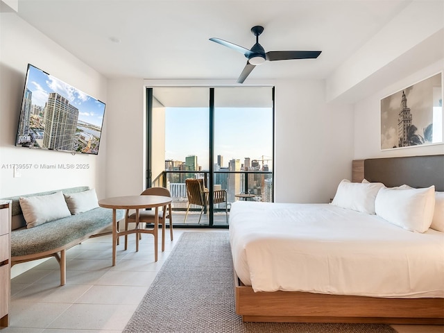 tiled bedroom with ceiling fan, floor to ceiling windows, and access to exterior