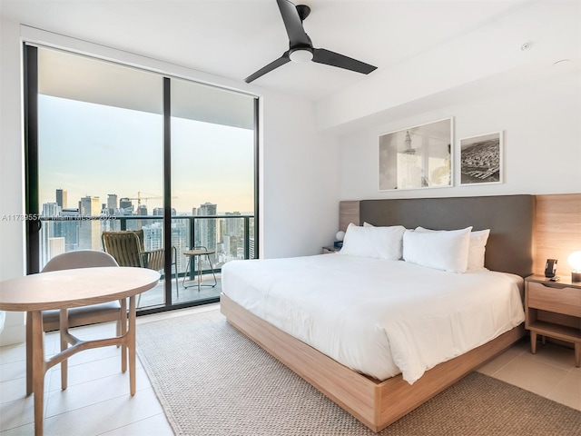 tiled bedroom with ceiling fan, floor to ceiling windows, and access to exterior