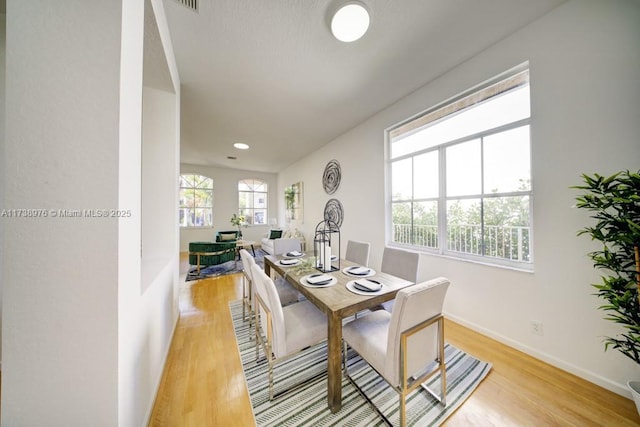 dining space with light wood-type flooring