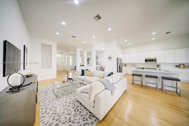 living room with light hardwood / wood-style flooring