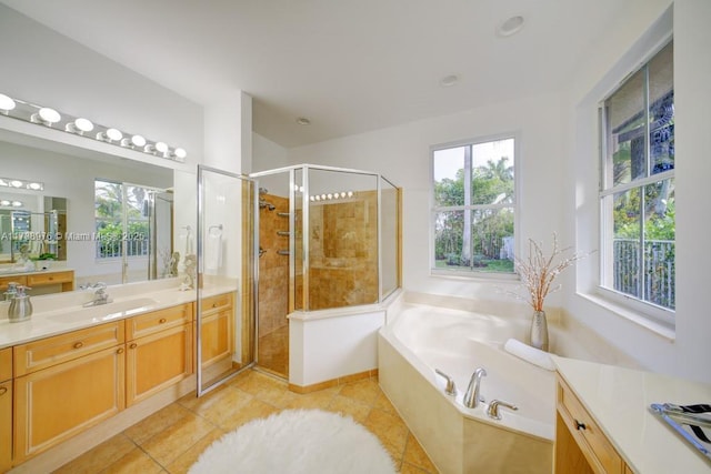 bathroom featuring vanity, tile patterned flooring, and separate shower and tub