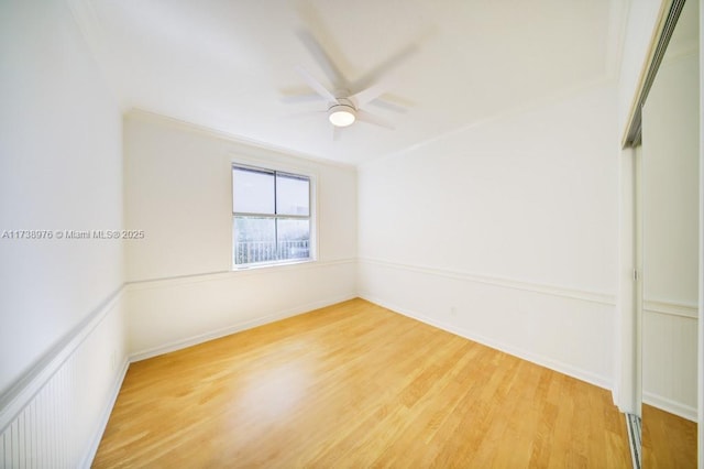 empty room with wood-type flooring and ceiling fan