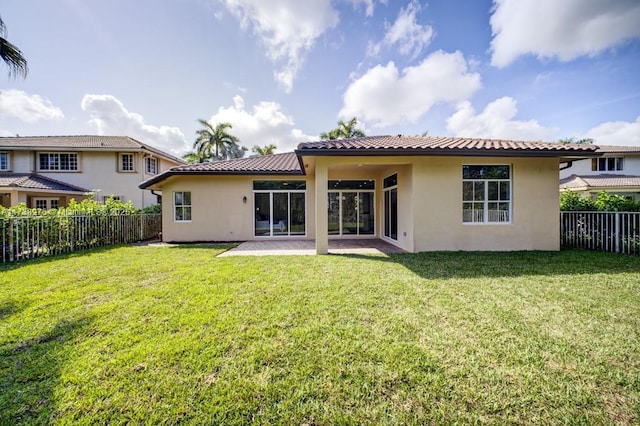 back of property featuring a yard and a patio area