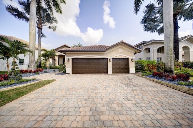 mediterranean / spanish home featuring a garage