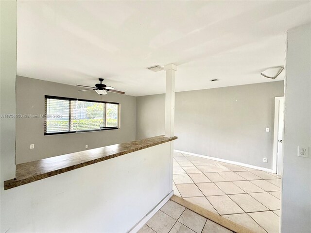 kitchen featuring white cabinetry, stainless steel appliances, decorative backsplash, and light tile patterned floors