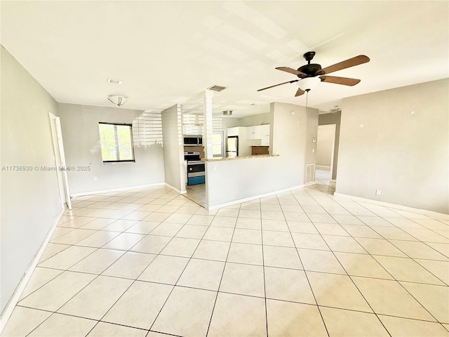 unfurnished living room with light tile patterned flooring, ceiling fan, and ornate columns