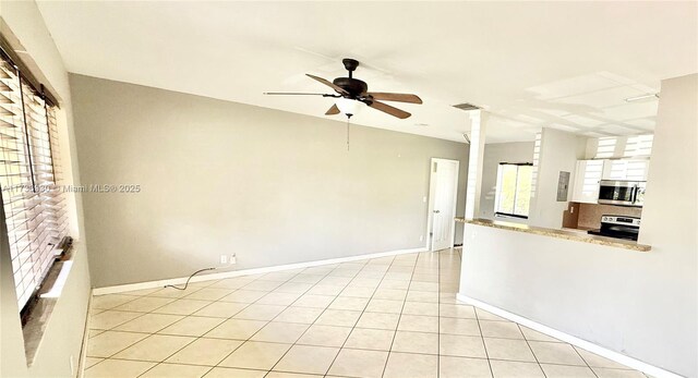 kitchen featuring white cabinetry, stainless steel appliances, ceiling fan, and light tile patterned flooring